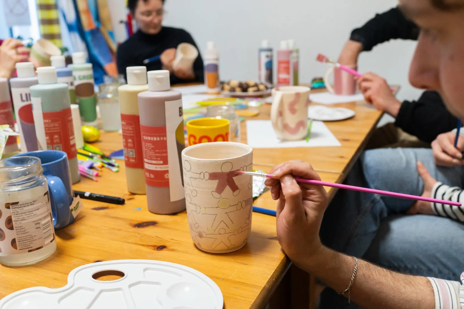 Decorated mugs on window ledge